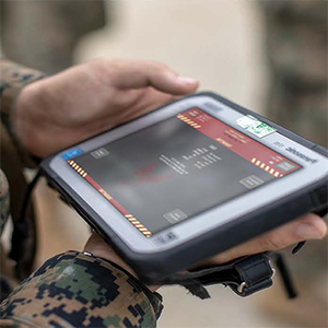 Soldier holding a rugged field tablet running the interface