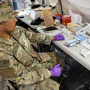 Clinician using the i-STAT handheld analyzer at the point of care
